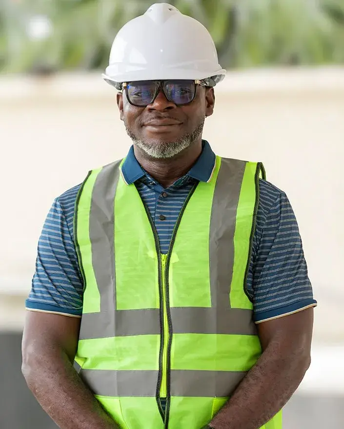 A site supervisor in a hard hat and safety vest